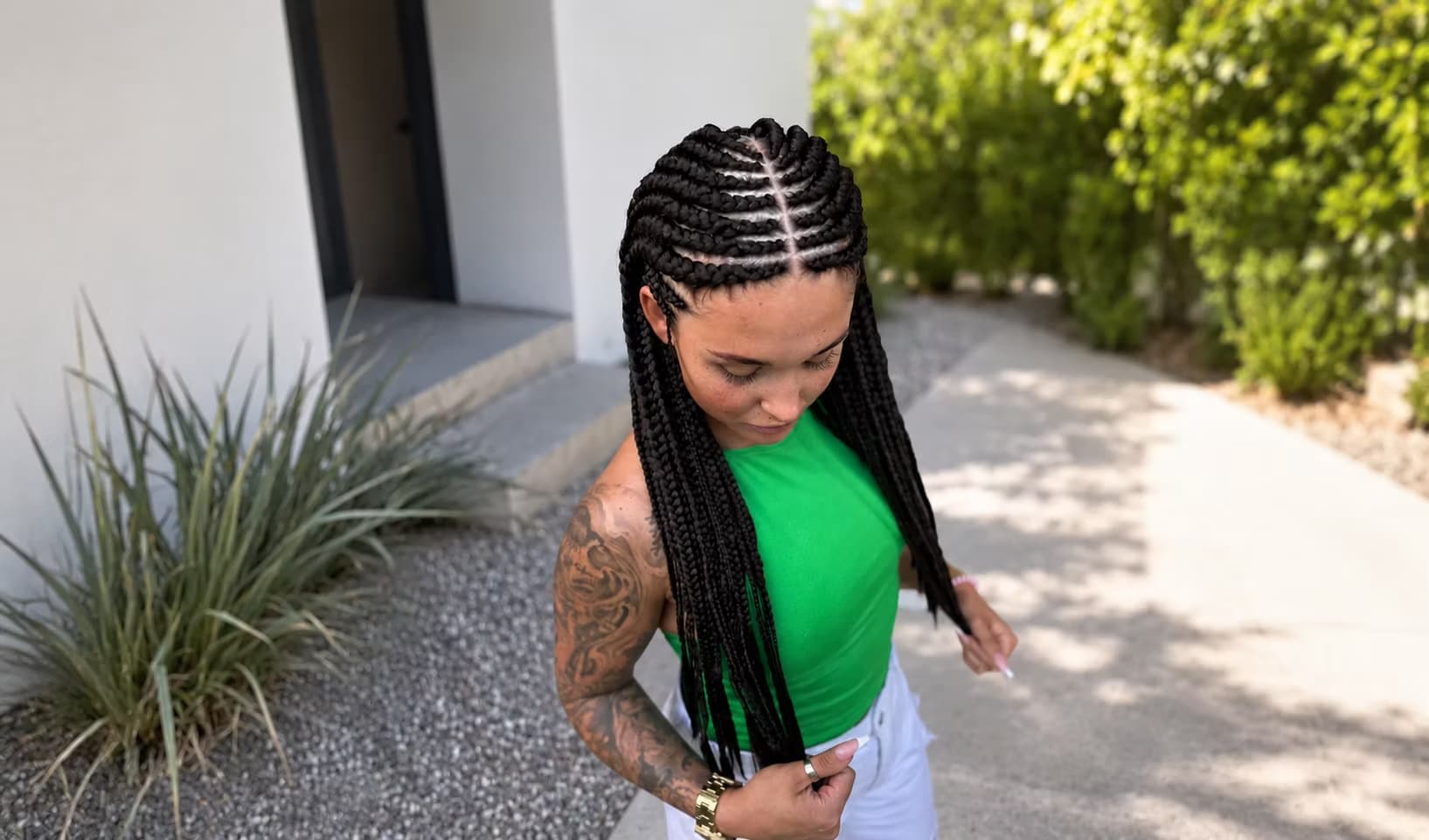 Zapletené cornrow copánky přecházející do dlouhých pramenů